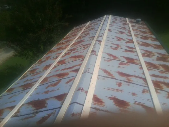 Rusted metal roof panels with new wood purlins before replacement — Storm Damage Roof Repair in Lagrange by Roofing Brothers