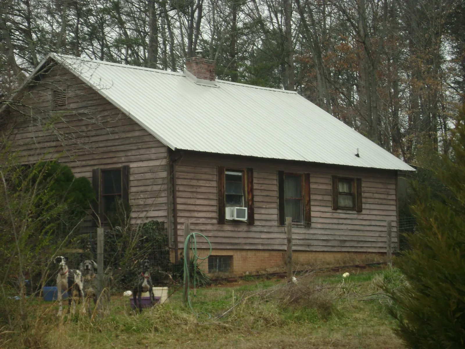 White metal roof on an old wood sided farmhouse, from a Asphalt Shingle Roof Repair job in Lagrange